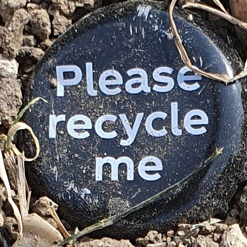 Please recycle me bottle top in dirt